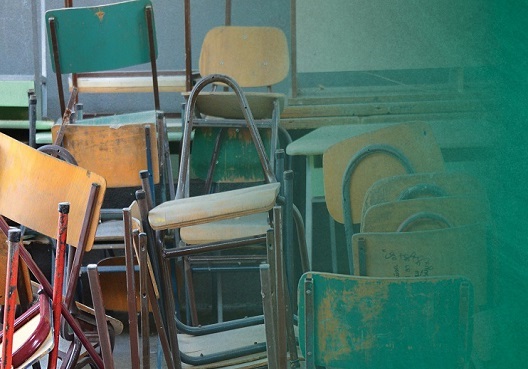 Several stacks of chairs in a classroom.