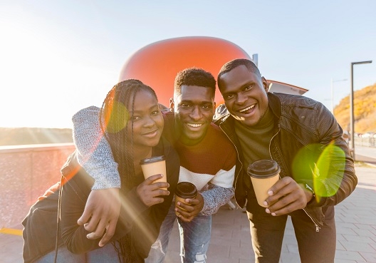 Two men and a woman spend time together at an event about youth unemployment. 