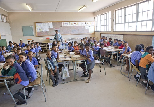 Schoolchildren pay attention to their teacher during a class.