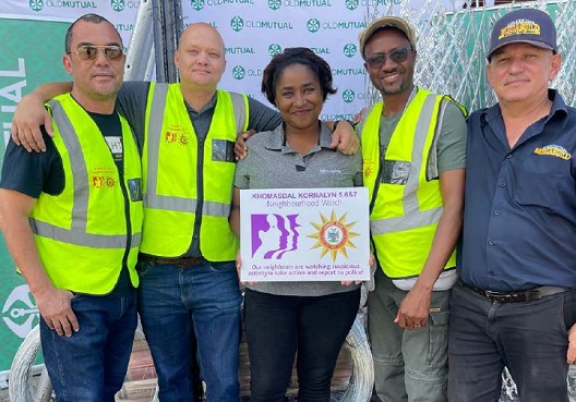 Men belonging to a Namibian neighbourhood watch group hold matching yellow vests. 