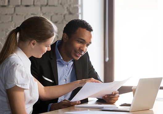 A customer listens to an insurance broker break down a quote for car and home insurance.